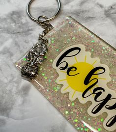 a keychain with the words be happy on it