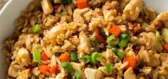 a bowl filled with rice and vegetables on top of a table