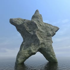 a large rock in the water with a star on it