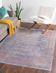 a living room with a couch, chair and rug