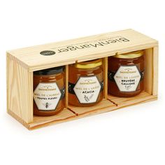 three jars of honey in a wooden box