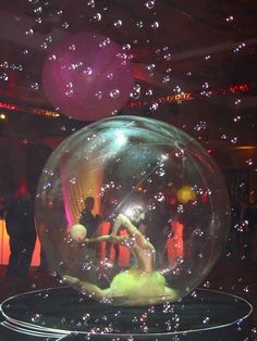 a person is in a bubble ball with bubbles all over it and people standing around