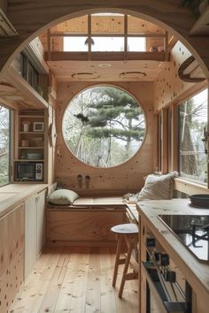 the inside of a tiny house with a large round window in it's center