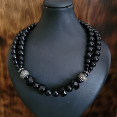 "This is an exquisite vintage short length/ choker necklace made out of genuine black onyx stones, 2 sterling silver spacer beads which are embellished with marcasite stones, and a sterling silver toggle clasp.  2 strands of round black onyx beads on both sides then 2 sterling spacers and one strand in between which contains round and faceted black onyx gemstones.  There's no mark on this necklace but the toggle clasp and spacers are individually tested and they are sterling silver.  In excellen Black Double Strand Faceted Beads Jewelry, Elegant Black Rondelle Beaded Necklaces, Vintage Black Gemstone Beads Necklace, Black Double Strand Polished Bead Jewelry, Elegant Sterling Silver Necklace With Black Beads, Black Beaded Rondelle Jewelry, Black Rondelle Spacer Beads Jewelry, Black Rondelle Gemstone Bead Necklace, Elegant Black Sterling Silver Beaded Necklaces