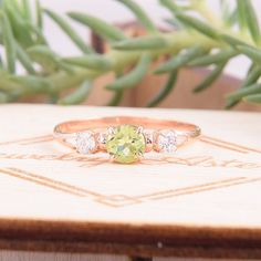 "Simple & dainty 14k rose gold peridot promise ring for her, Elegant 3 stone womens promise ring, Gold 3 stone peridot engagement ring WE OFFER UNLIMITED PERIOD INSTALLMENTS PLAN This is a beautiful, stunning, feminine ring that works well for all occasions, styles, and ages. You will love it! Ring information Main stone: Peridot Approximate size: 4.5mm Accent stone: Cubic zirconia Approximate size: 3mm Metal type: Gold Metal stamp: 14k solid gold Customization / Replacements It's easy to cr Three-stone Fine Jewelry For Proposal, Fine Jewelry Three Stone For Proposal, Three Stone Fine Jewelry For Proposal, Rose Gold Three Stone Jewelry, Rose Gold Cubic Zirconia Three Stone Jewelry, Rose Gold Three Stone Cubic Zirconia Jewelry, Three Stone Round Cut Jewelry For Proposal, Rose Gold Three Stone Jewelry As A Gift, Rose Gold Three Stone Jewelry For Anniversary