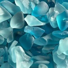 blue and white glass pebbles are piled together