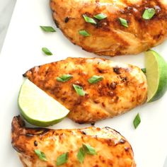 grilled chicken with lime wedges on a white plate