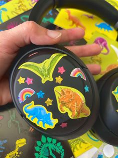 Black sony headphones with colorful glitter dinosaur and stars stickers Dinosaur With Headphones, Dinosaur Aesthetic, Dinosaur Stuff, Dinosaur Stickers, Jurassic Park World, Kid Core, Jurassic World, Jurassic Park, My Vibe