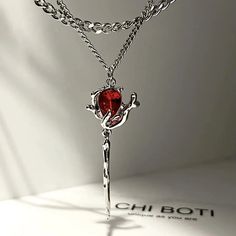 Description: Welcome to our collection of exquisite stainless steel jewelry, where elegance meets innovation. Behold our stunning Double Layer Rose Pendant Necklace, a true testament to beauty and craftsmanship. Crafted with precision and care, this necklace features a unique design with double layers of delicate rose pendants, each adorned with vibrant red zircon stones. The intricate detailing and irregular floral aesthetic make this piece a standout addition to any jewelry collection. The red zircon stones add a pop of color and sparkle, elevating the necklace to a new level of sophistication. Whether you're dressing up for a special occasion or adding a touch of glamour to your everyday look, this necklace is sure to turn heads and spark conversations. Designed to be versatile and time Collar Rosa, Rose Pendant Necklace, Punk Earrings, Y2k Accessories, Crystal Heart Pendant, Beaded Tassel Necklace, Dark Rose, Kawaii Jewelry, Rose Pendant