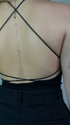 the back of a woman's top with writing on it