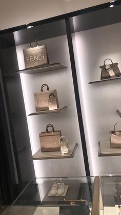 the display case is filled with purses and handbags