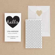 the business card and envelope are next to each other, with a heart on it