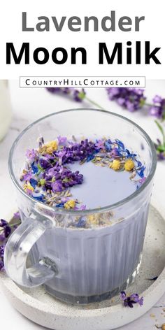 lavender moon milk in a glass cup with flowers on the side and text overlay