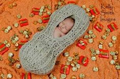 a baby wrapped in a blanket surrounded by candy candies and gold flecks