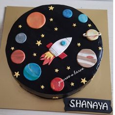 a birthday cake with an outer space theme on it