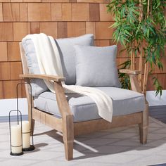 a chair sitting on top of a rug next to a plant