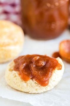 some type of bread with sauce on it next to a jar of peanut butter and jelly