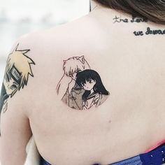 the back of a woman's shoulder with an anime character tattoo on her upper arm