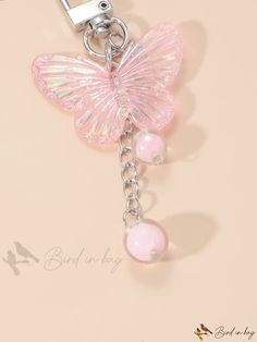 a pink key chain with a butterfly on it