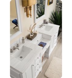 a bathroom with two sinks, mirrors and rugs on the floor in front of it