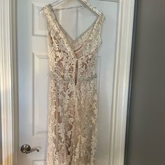 a dress hanging on a door with a hanger in front of it that has an open back