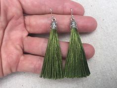 "Chic olive green tassel earrings! They would add a pop of color to any outfit for any occasion. Dress them up or down. They are timeless and versatile. They are lightweight, fun and unique! The tassels measure 2 1/8\" long by 1/4\" wide. They hang from simple silver ear wire hooks. Overall drop length is about 2 1/4\". Metal is allergy free plated silver. These are my latest creation! I have them available in many colors! Find them all under the category tassel earrings in my shop. Thanks for s Green Tassel Drop Earrings, Green Tassel Dangle Earrings, Green Beaded Tassel Drop Earrings, Green Tassel Drop Earrings As Gift, Green Tassel Earrings For Gift, Green Tasseled Jewelry For Gifts, Olive Green Jewelry, Green Tassel Earrings, Crescent Moon Jewelry