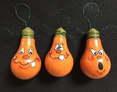 three orange pears with faces drawn on them