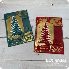 two christmas cards with gold foil and red paper on white wood planks, one has a tree