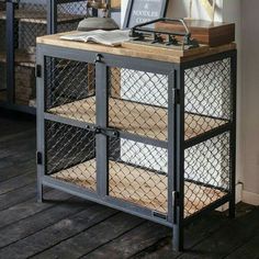 a metal and wood side table with books on top