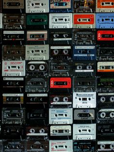 a large amount of cassette tapes stacked on top of each other