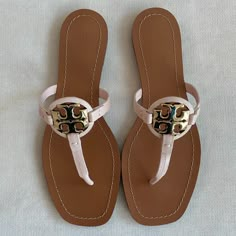 This Is A Pair Of Brand New Tory Burch Miller Thong Sandals. They Are Seashell In Color And A Size 8. Open Toe T-Strap Thong Design Gold-Tone Logo Emblem Leather Upper, Lining And Sole Made In Brazil You Will Receive Exactly What Is Pictured! They Will Ship With The Box. Purchased From Bloomingdale's And Guaranteed 100% Authentic. Retail Price Is $178. Designer Leather Flip Flops For Beach, Designer Leather Flip Flops For The Beach, Beige Leather Flat T-strap Sandals, Tan Leather Open Toe Flip Flops, Leather Toe Post Flip Flops In Beige, Beige Leather Toe Post Flip Flops, Beige Leather T-strap Sandals, Chic Adjustable Leather Flip Flops, Beige Leather Round Toe Flip Flops