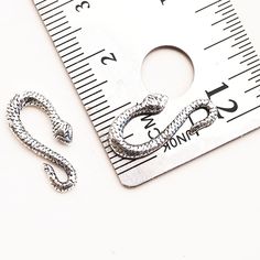 These Snake Hook clasps are made from sterling silver and they will hold up to heavy use! Use them in your bangles, earrings, necklaces, and anything else that needs a little slithery friend! They have a detailed front and the plain back is discreetly stamped 925. Each listing is for 1 S-Hook Clasp, or you can Buy in Bulk and Save! YOUR CHOICE: Single Head - 19mm long Double Head - 22mm long Symmetrical - 22mm long Questions? Contact us, we are happy to help! ►Click here to see more SNAKE findin Adjustable Clip-on Sterling Silver Jewelry, Nickel-free Silver Snake Chain Jewelry, Metal Clip-on Jewelry For Jewelry Making, S Hook, Hook Clasp, Jewelry Tools, Artisan Jewelry, Made In The Usa, Dog Tag Necklace