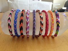 a bunch of bracelets sitting on top of a wooden table