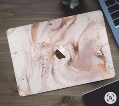 an apple laptop computer sitting on top of a wooden desk