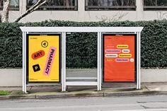 two bus stop displays on the side of the road