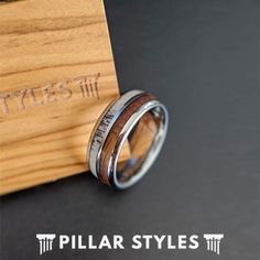 the ring is made from wood and has silver inlays on it's sides