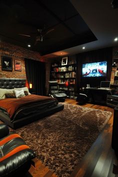 a bedroom with a bed, desk and television in the corner is lit by lights