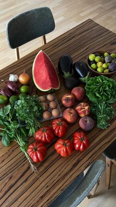 a table topped with lots of different types of fruits and veggies on top of it