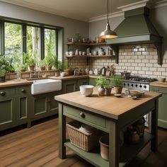 a kitchen with green cabinets and wooden floors