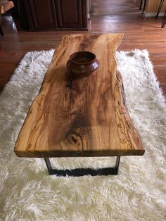 a wooden table sitting on top of a white rug