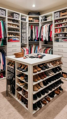 an organized walk in closet with lots of shoes