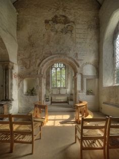 the inside of an old church with wooden pews