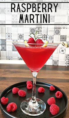 raspberry martini with fresh raspberries on the rim and garnish