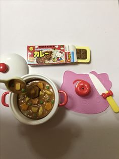 a bowl of soup with chopsticks and an eraser next to it on a table