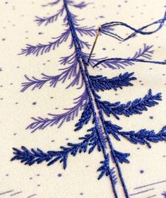 a close up of a piece of cloth with blue thread on it