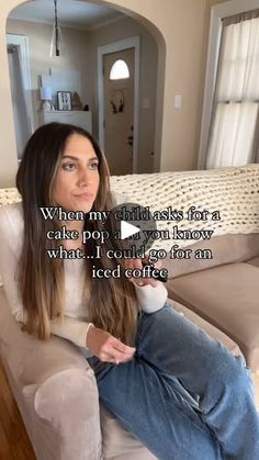 a woman sitting on top of a couch in a living room