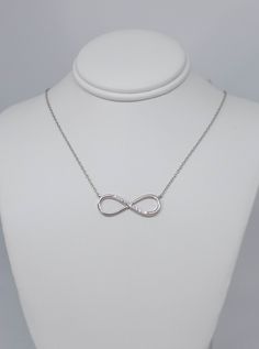 Beautiful sterling silver infinity Necklace with this cubic zirconia, Inspired by ancient infinity signs, meaning eternal connection It like the endless love between lovers, families, and friends. I recommend putting your jewelry on last when getting ready, as direct exposure to hair-styling products and perfume will often also damage the metal and gemstones. Do NOT use jewelry when swimming in chlorinated, thermal or salt water OR when showering. Also avoid wearing silver while exercising as th Silver Infinity Jewelry For Anniversary, Infinity Jewelry With Diamond Accents For Gift, White Gold Infinity Jewelry With Cubic Zirconia, White Gold Infinity Cubic Zirconia Jewelry, Silver Infinity Jewelry With Cubic Zirconia, Silver Infinity Jewelry, Sterling Silver Infinity Jewelry With Diamond Accents, Hypoallergenic Sterling Silver Infinity Jewelry, Hypoallergenic Infinity Sterling Silver Jewelry