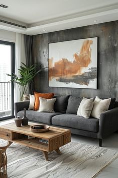 a living room filled with furniture and a painting hanging on the wall above it's windows