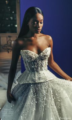 a woman in a white wedding dress is looking down