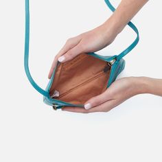 This mini crossbody is perfect in its simplicity, with a zip pocket and room for your keys, wallet and phone. Cara Crossbody In Polished Leather  Biscayne Blue SLG CROSSBODY Bag in Blue | Hobo® Blue Versatile Phone Bag For Everyday Use, Versatile Blue Phone Bag For Everyday Use, Everyday Blue Phone Bag, Casual Blue Crossbody Bag, Blue Crossbody Phone Bag For Everyday, Versatile Everyday Blue Phone Bag, Everyday Blue Phone Bag With Zipper Closure, Everyday Blue Phone Bag With Adjustable Strap, Blue Phone Bag With Zipper